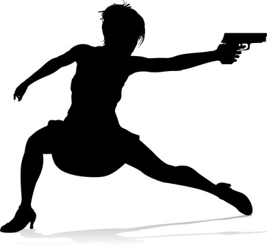 An action hero female movie star woman in silhouette. In a hitman, spy or secret agent detective type role halding a hand gun.