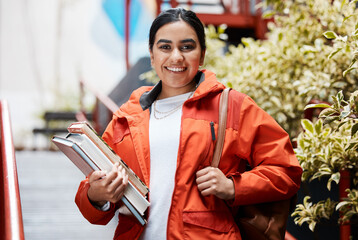 Books, education and portrait of student Indian girl on campus for learning at college or university. Bag, smile and study with happy academy pupil at school for development, knowledge or scholarship