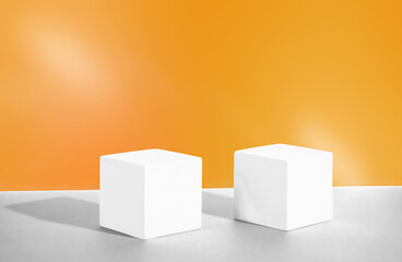 Cosmetic yellow background with geometric podiums. Two white cement cubic display. Mockup for the demonstration of cosmetic products