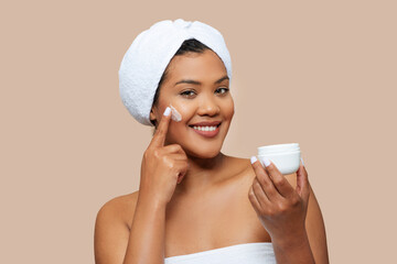 Radiant Young Woman Applying Facial Cream After Bath