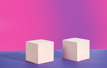 Two pink cement cubic display on a pink gradient background. Mockup for the demonstration of...