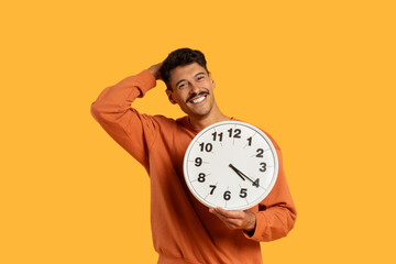 Man Holding Clock in Front of His Face