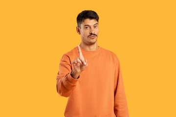 Man in Orange Sweater Points at Something