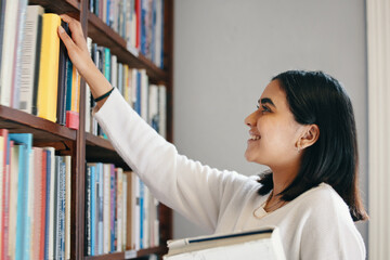 University, woman and student in library, searching and school with education, smile and knowledge. Happy person, college and girl with novel, literature and bookshelf with scholarship and studying