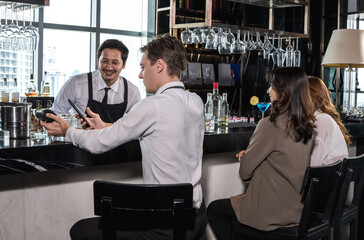 Office worker man and woman hang out and drinking wine at counter bar after work