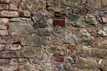 in the photo there is a close-up of an old stone wall