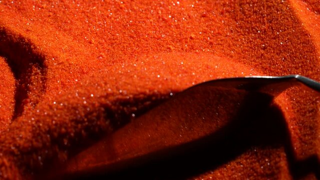 Small bright orange crystals of potassium dichromate, close up, abstract colorful background
