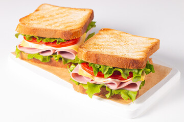 Club sandwich with ham, cheese, tomato and lettuce. 