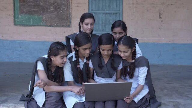 E-learning- Group of Rural indian schoolgirls using laptop, Learn computer technology at elementary school. Smart Kids, Knowledge, Digital India.