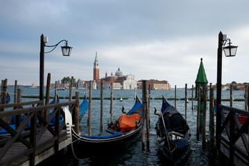 Scenic view of gondolas and boats docked at the pier on calm waters