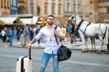 Traveler with suitcase. Traveler tourist man in casual clothes with suitcase. Man travel abroad...
