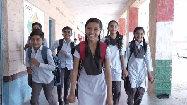 Education Concept, Cheerful indian students running home outside classroom in school corridor. Rural india children. Slow motion shot.