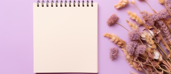 Spiral notebook blank page on purple backdrop