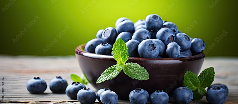 Poster Blueberries in bowl on wooden table