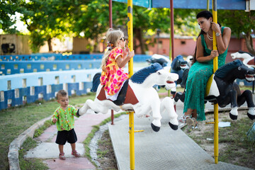girl sitting on a carousel, carousel horses, abandoned park, children's entertainment, carousel for...