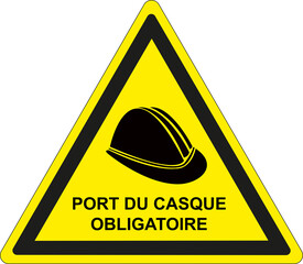 Panneau du chantier sur fond jaune et bordure noire avec texte en français: Le port d'un casque est obligatoire	 - 793789460
