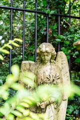 Ein Engel steht vor einem Zaun auf dem Highgate Cemetery in London Camden