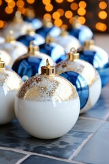 b'A beautiful arrangement of blue and white Christmas ornaments with gold accents'