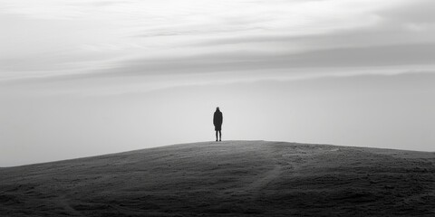 Lonely Man Standing on Top of Hill Black and White