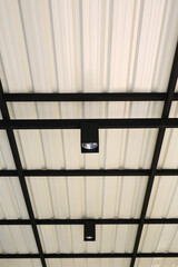 Bulb hanging from the roof of metal sheet structure. - 793792893