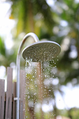 Outdoors shower while running water in the garden.