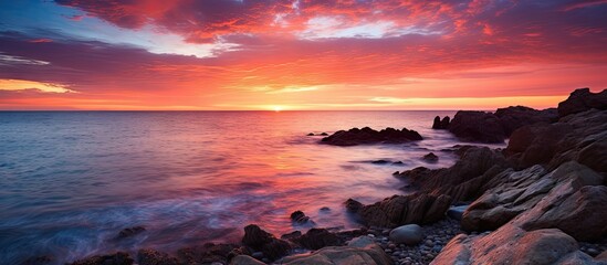 Ocean sunset with rocks and water
