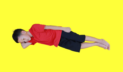 Sleeping Asian boy with arm support his head isolated on yellow background. Full length. - 793797641