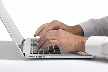 Hands writing on computer keyboard with white background. Topics related to the business world. Computer related topics. Image for graphic designer. Telework. Coworking. Hands and computer. Computer w