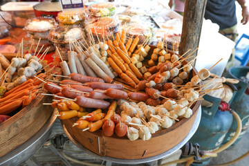 Steamed hot dogs and meatballs in a wooden tray,Food at the local market in Ao Nang City, Krabi Province