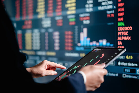 Investors analyze the data stock market index via digital tablet screen to trade the stock chart for planning investments take profit, trade stock exchange market and cryptocurrency data, financial.