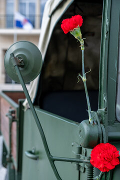 two red carnations decorating a military vehicle during the commemoration of April 25th in Portugal. Revolu&ccedil;ao dos Cravos.