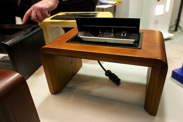 Monitor table with built-in communications for connecting wires and connectors.