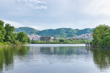 TIRANA, ALBANIA - APRIL 22, 2024: View of the artificial lake of the Grand Park of Tirana, Albania. This was during sunset on a cloudy spring evening. 