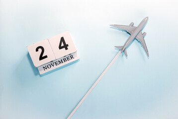 November calendar with number  24. Top view of a calendar with a flying passenger plane. Scheduler....