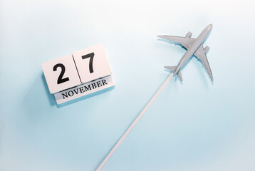 November calendar with number  27. Top view of a calendar with a flying passenger plane. Scheduler....