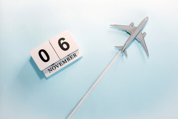 November calendar with number  6. Top view of a calendar with a flying passenger plane. Scheduler....