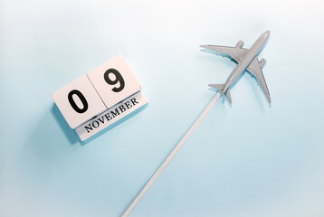 November calendar with number  9. Top view of a calendar with a flying passenger plane. Scheduler....