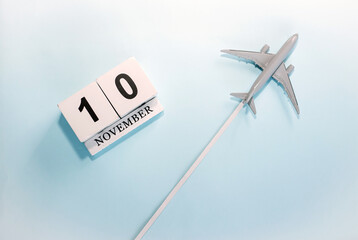 November calendar with number  10. Top view of a calendar with a flying passenger plane. Scheduler....