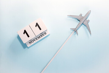 November calendar with number  11. Top view of a calendar with a flying passenger plane. Scheduler....