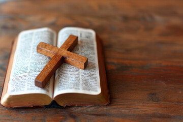 a simple light oak colored cross on a open bible .