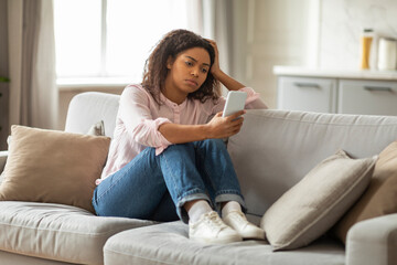 African American Lady Overwhelmed by Digital Communication at Home