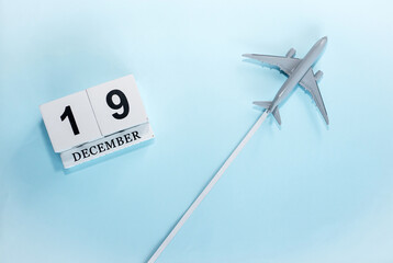December calendar with number  19. Top view of a calendar with a flying passenger plane. Scheduler....