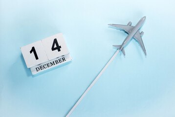 December calendar with number  14. Top view of a calendar with a flying passenger plane. Scheduler....