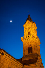 tower of the church of dinkelsbühl germany at night with moon