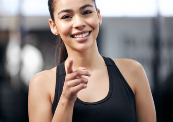 Portrait, girl and pointing in gym, smile and fitness with training, health and recruitment to...