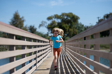 Morning running with children. Child runner running in the nature. Morning jogging. Active healthy kids lifestyle.