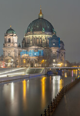 Picturesque view of The historic berlin cathedral building with a bridge over the river Spree at...