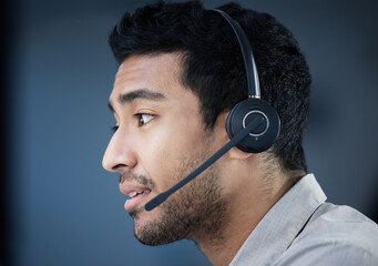 Call center, face and headset with Indian man in telemarketing office for customer support....