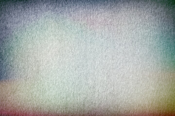 White felt abstract background with colorful vignette. Surface of fabric texture in white winter...