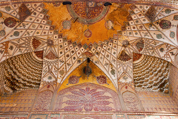 Fototapeta na wymiar Colourful paintings on the inner wall of West gate of the Akbar's Tomb, Sikandra, Agra, Uttar Pradesh, India